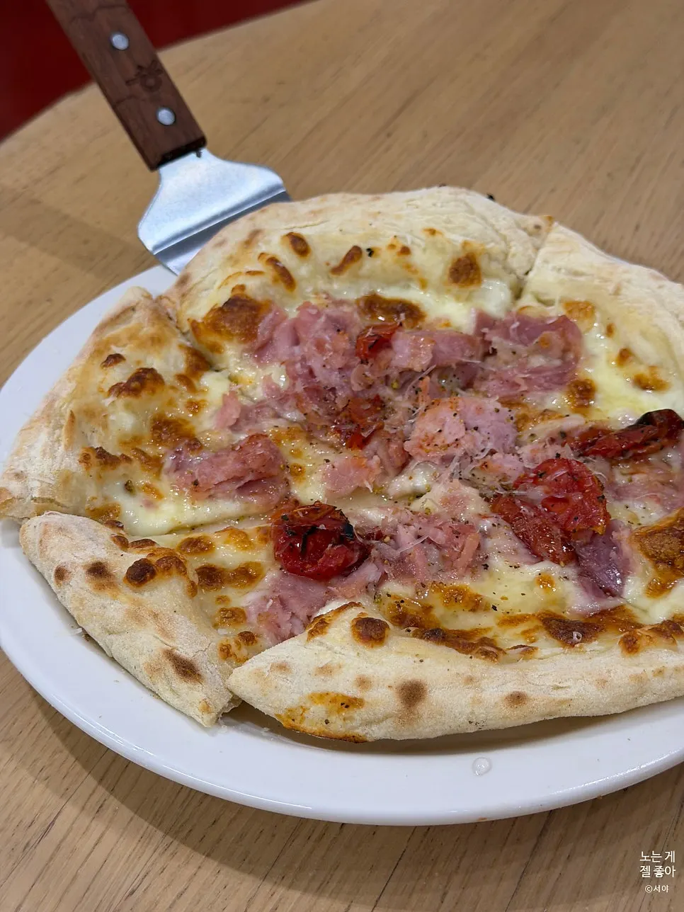 A whole jambon pizza baked with ham on top