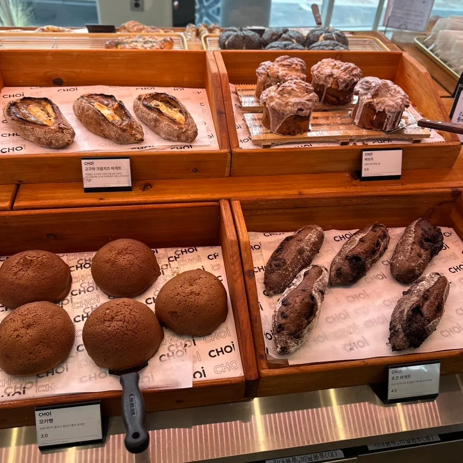 Display case with egg tarts and salt bread loaf