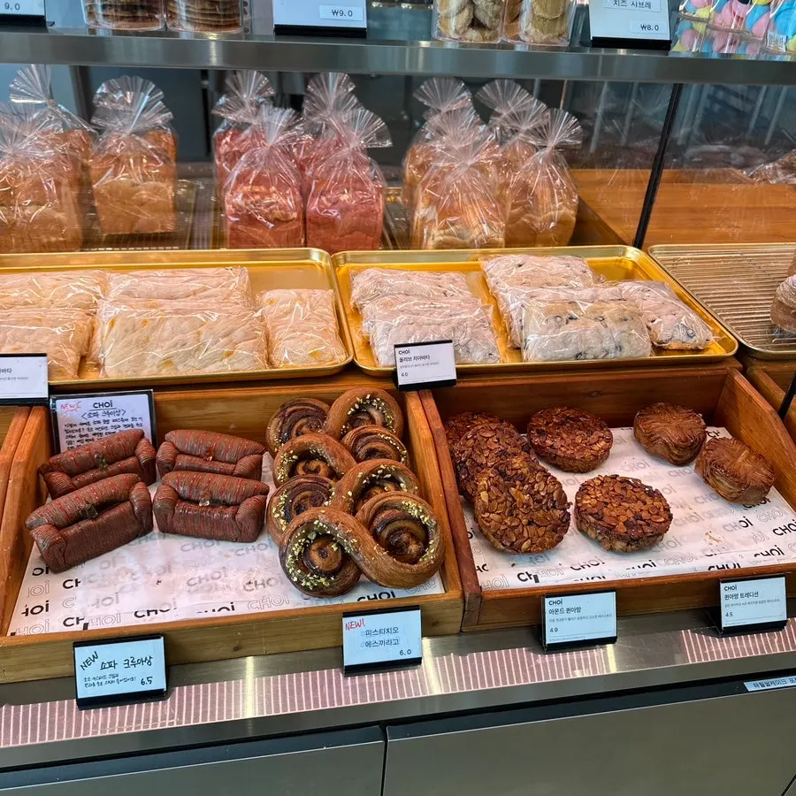 Display of savory breads including sausage bread and babka