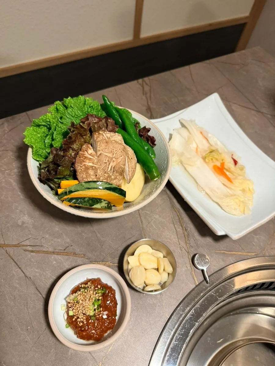 Table spread with wrap greens, baek-kimchi, and chive pickles