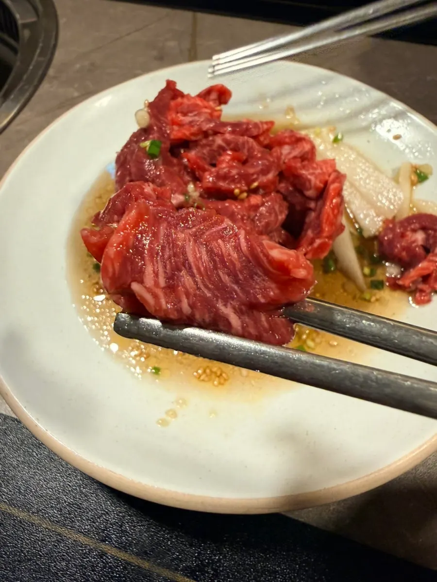 Close-up of Korean beef yukhoe drizzled with soy sauce