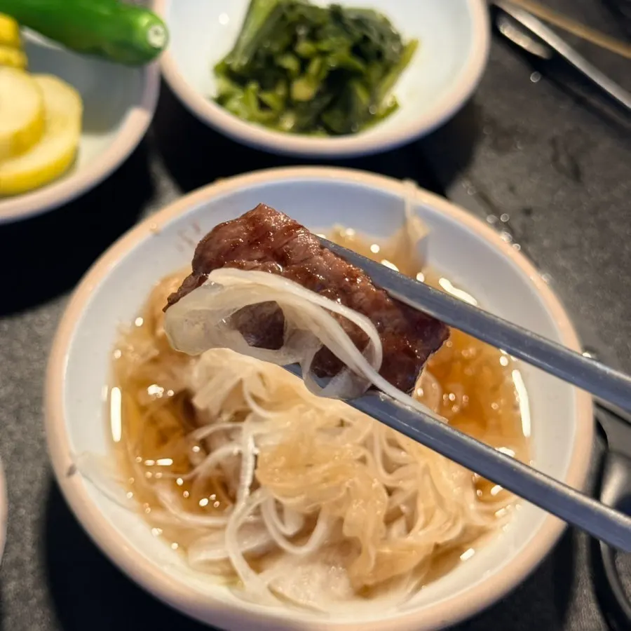 A piece of grilled Korean beef served with salt and onion