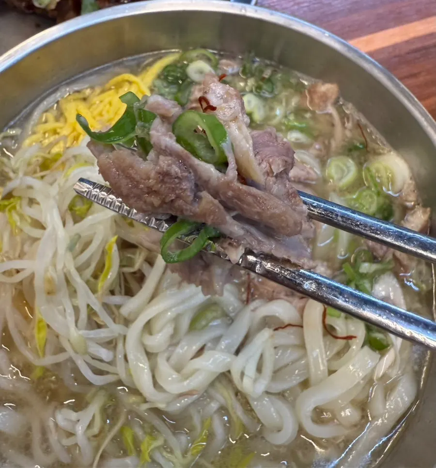 Bone kalguksu with mung bean sprouts and shredded egg