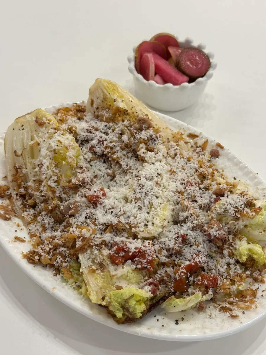 Napa cabbage Caesar salad topped with cheese
