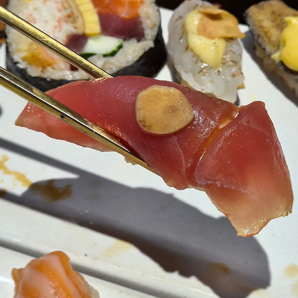 Sushi showing the dark reddish vinegared rice