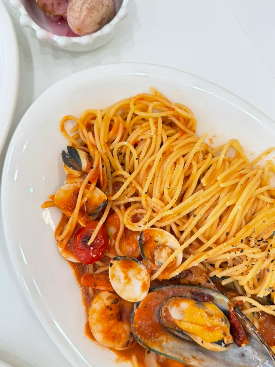 A plate of seafood tomato pasta