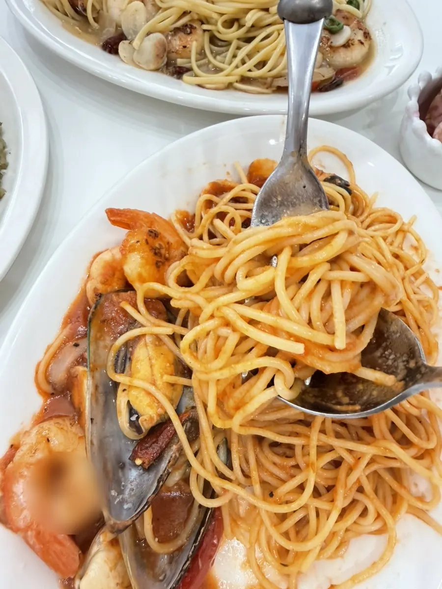 Tomato pasta topped with shrimp and mussels