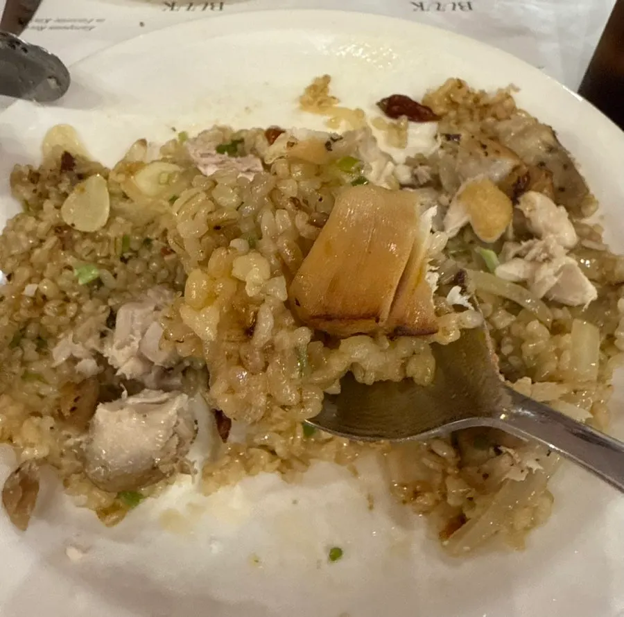Kung Pao chicken pilaf topped with a whole chicken leg