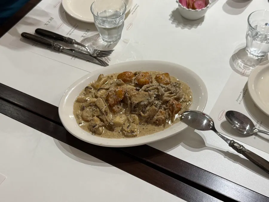Table set with gnocchi, pasta, pizza, and pilaf together