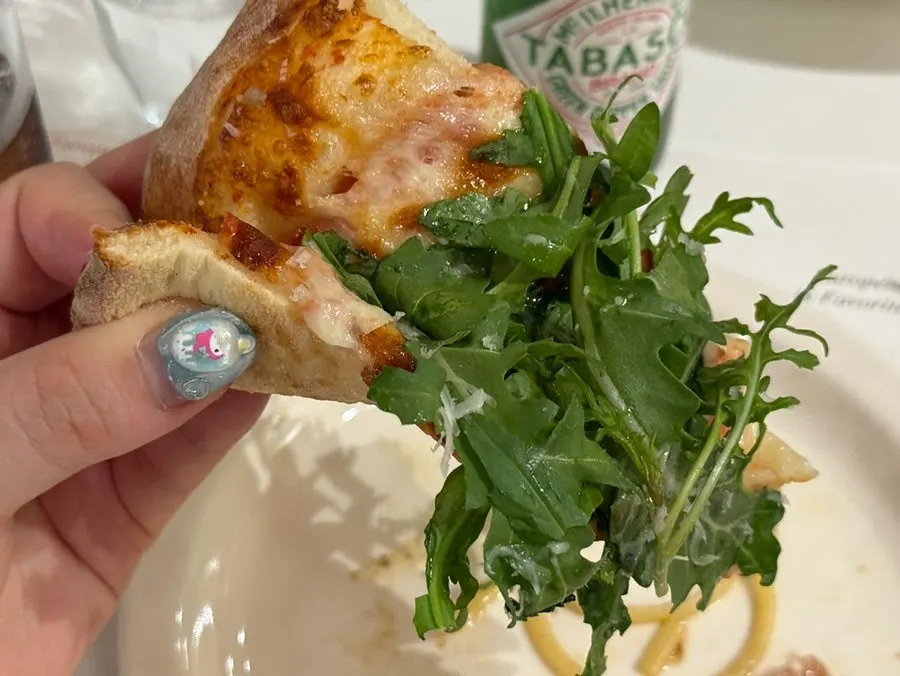 Pizza generously topped with arugula