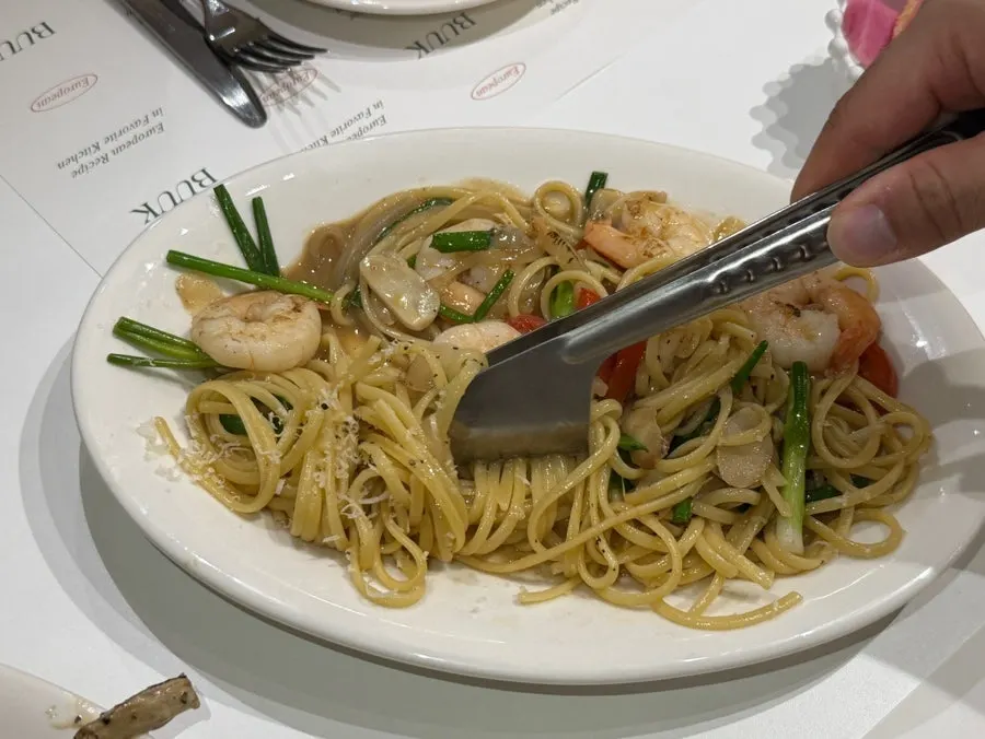 Close-up of plump shrimp on oil pasta