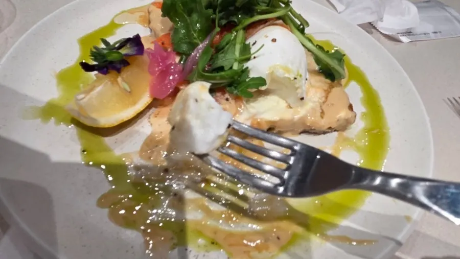 Poached egg and arugula on the smoked salmon toast