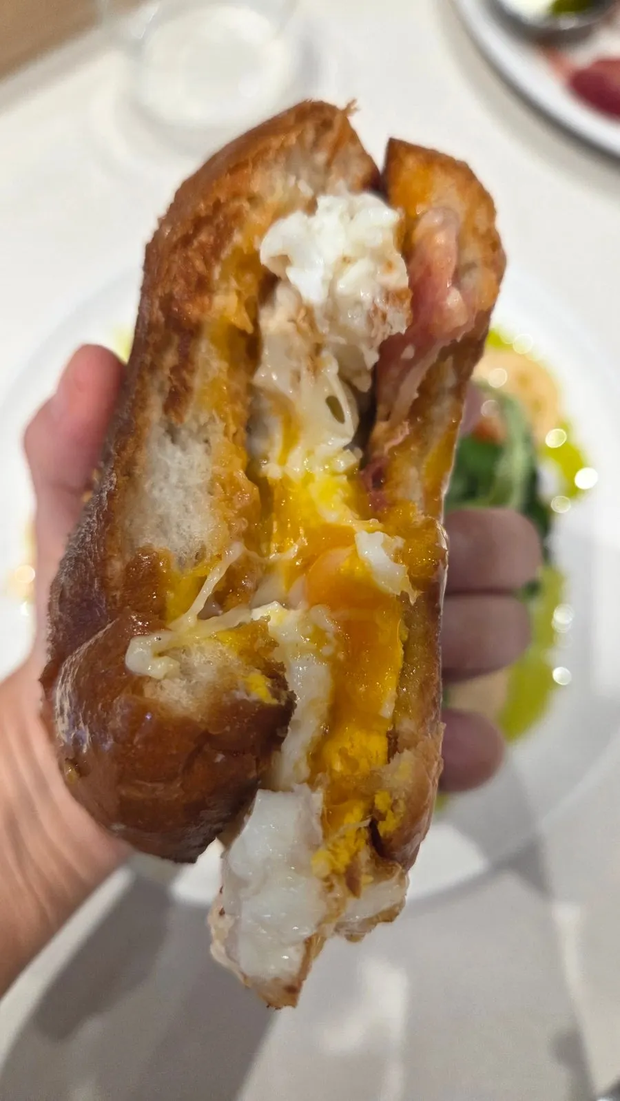 Bacon egg roll with bacon and sunny-side-up egg in a burger bun