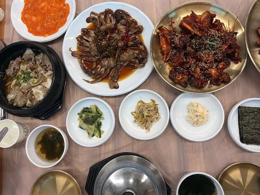 Table filled to the brim with a crab jang spread