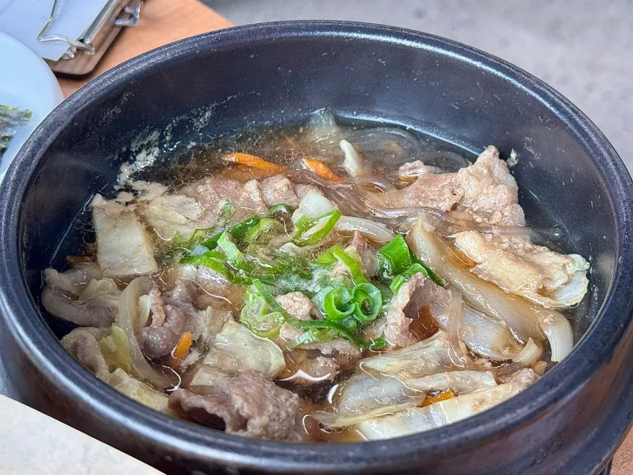Pot rice after scooping and a bowl of rice