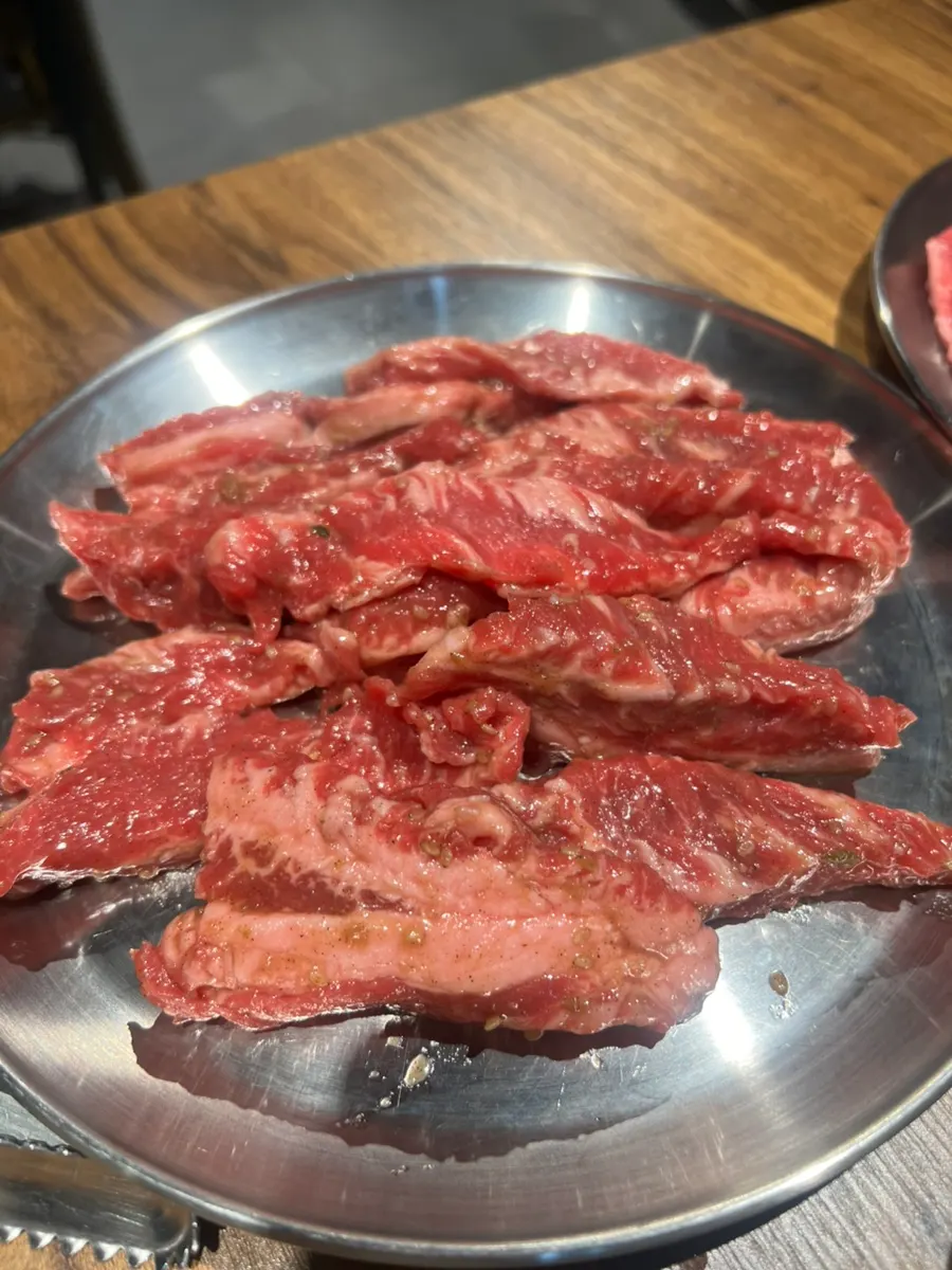 A piece of charcoal-grilled beef dipped in special sauce