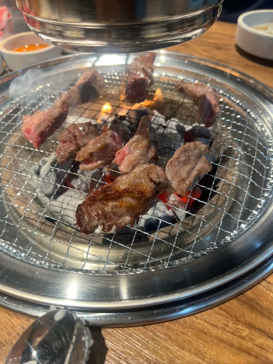 Marinated beef cooking on the charcoal grill