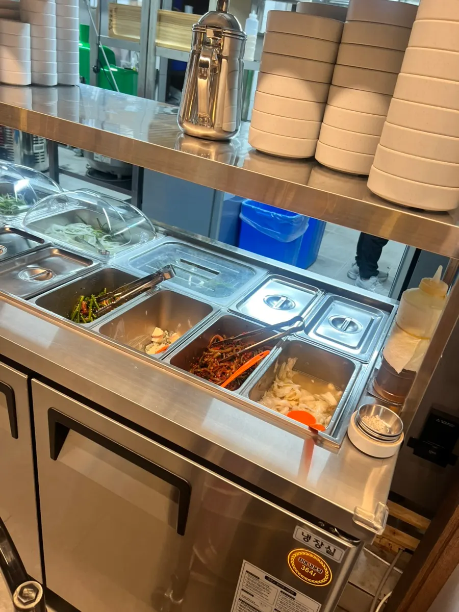 Tongs, scissors, and other utensils arranged at the self-serve bar