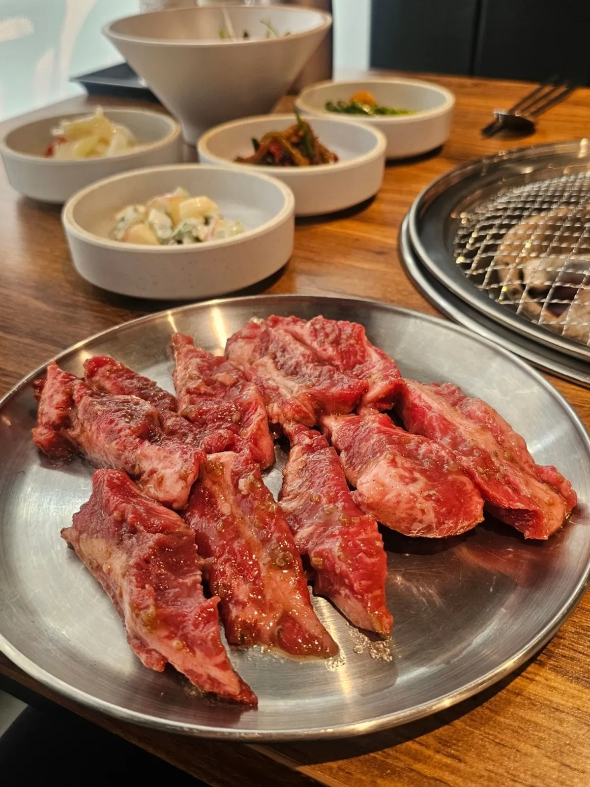 Grilling Yangsimso's marinated galbisal over charcoal