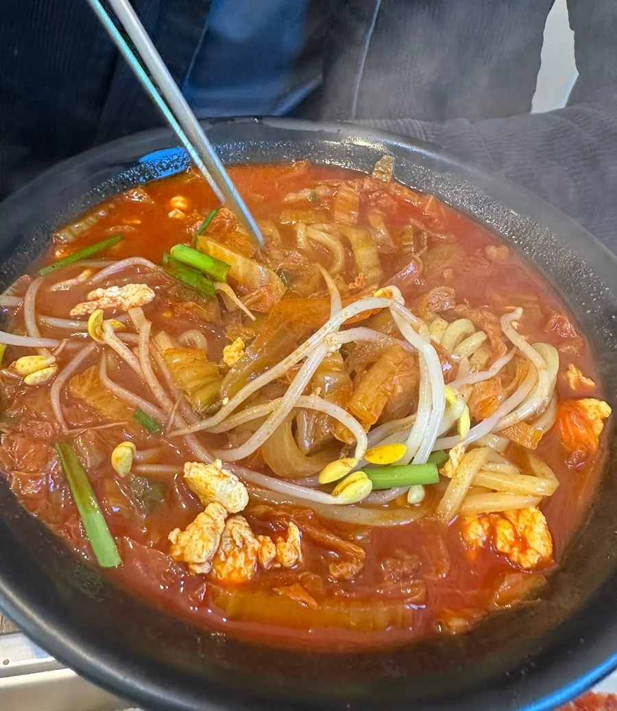 A bowl of chicken jjamppong served with noodles
