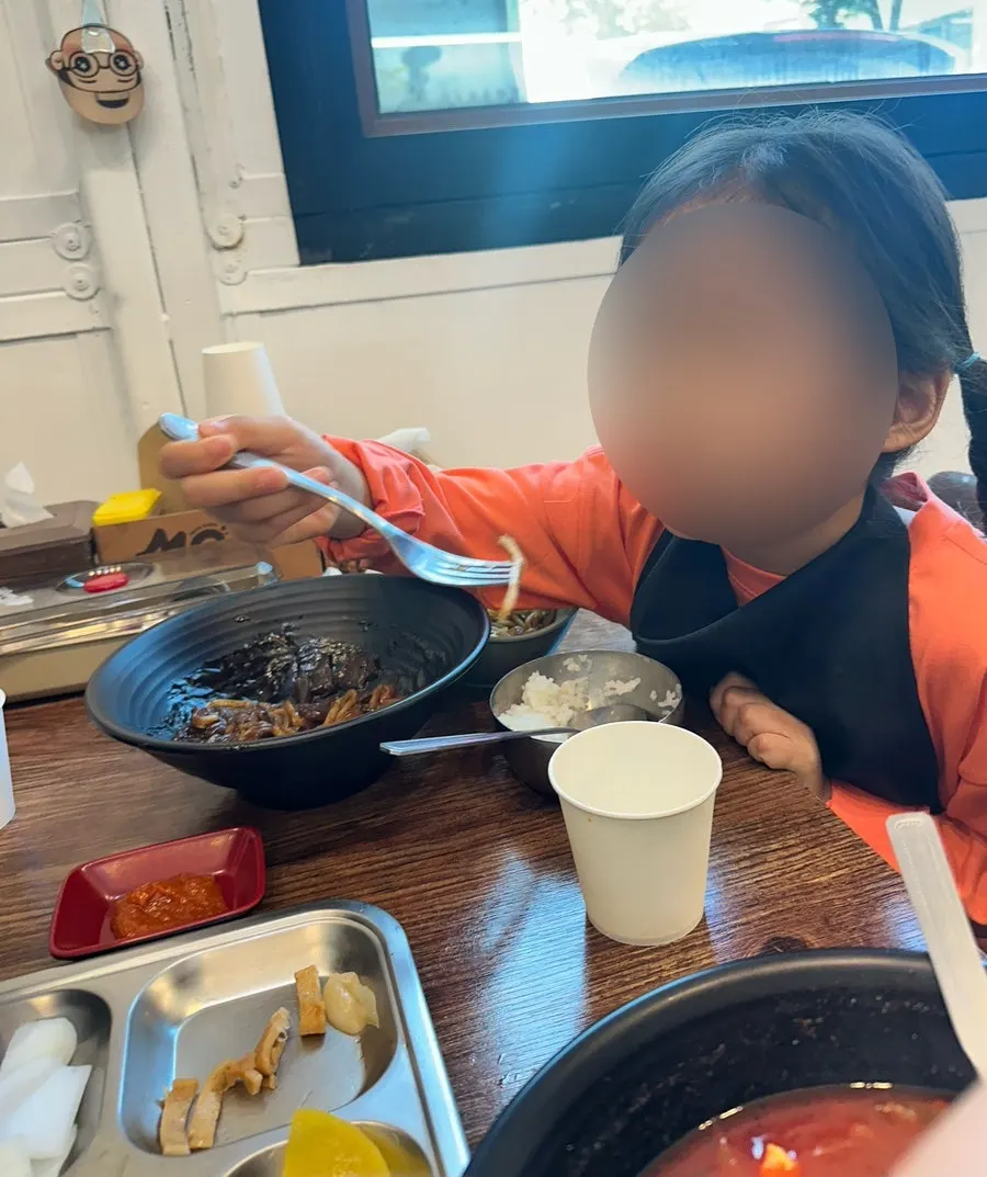 Child eating the jajangmyeon