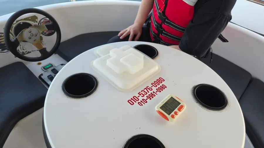 Family aboard an electric boat on the calm Namdaecheon River