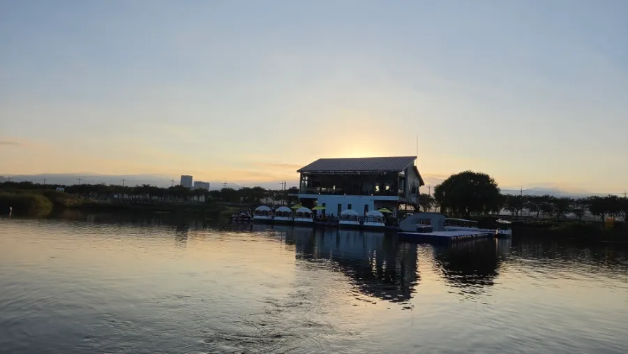 Sunset-lit view of the Namdaecheon River and the floating café
