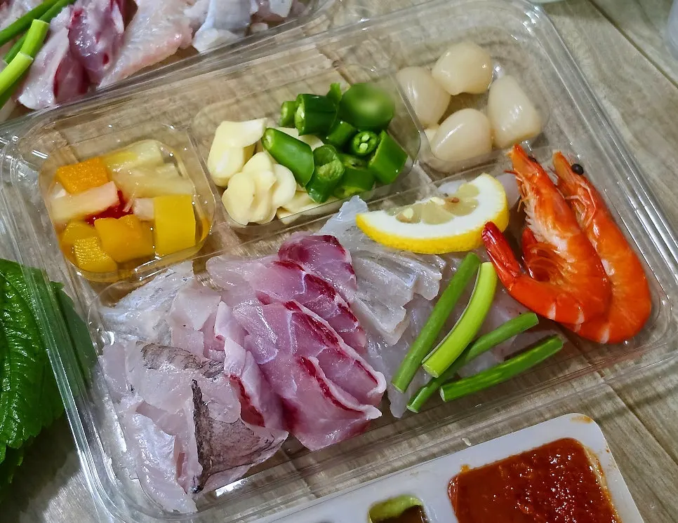Abalone sashimi, sea squirt, shrimp, and whelk alongside the sashimi