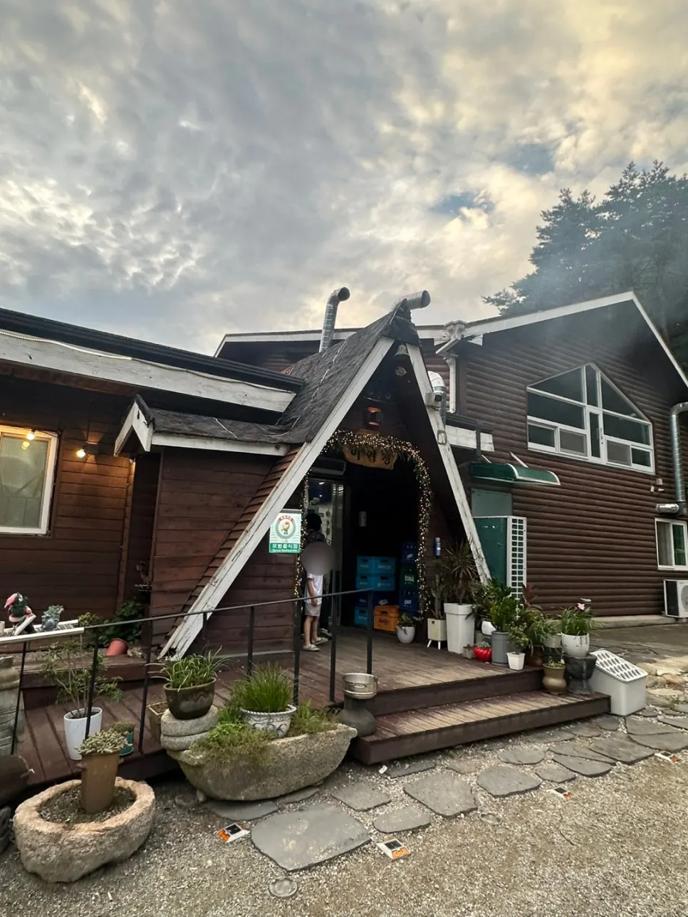 Evening exterior of Yeoyejeong's log-cabin building in Yangyang