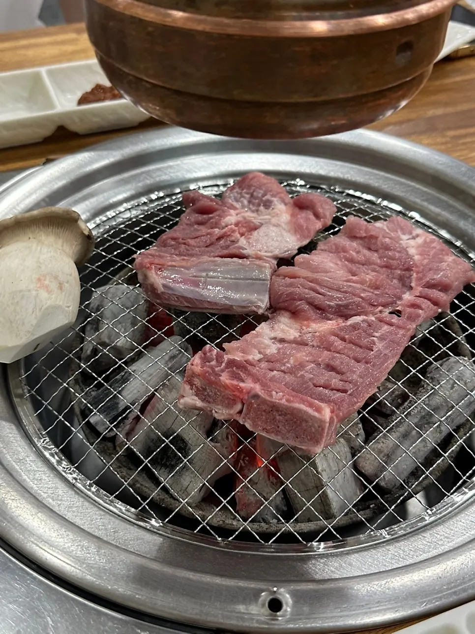 Thick fresh ribs placed on the charcoal grill