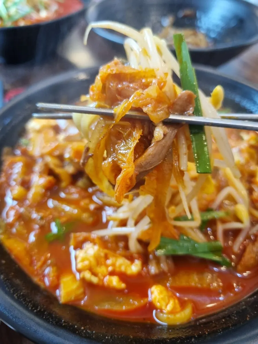 Chicken jjamppong ingredients loaded with kimchi and meat