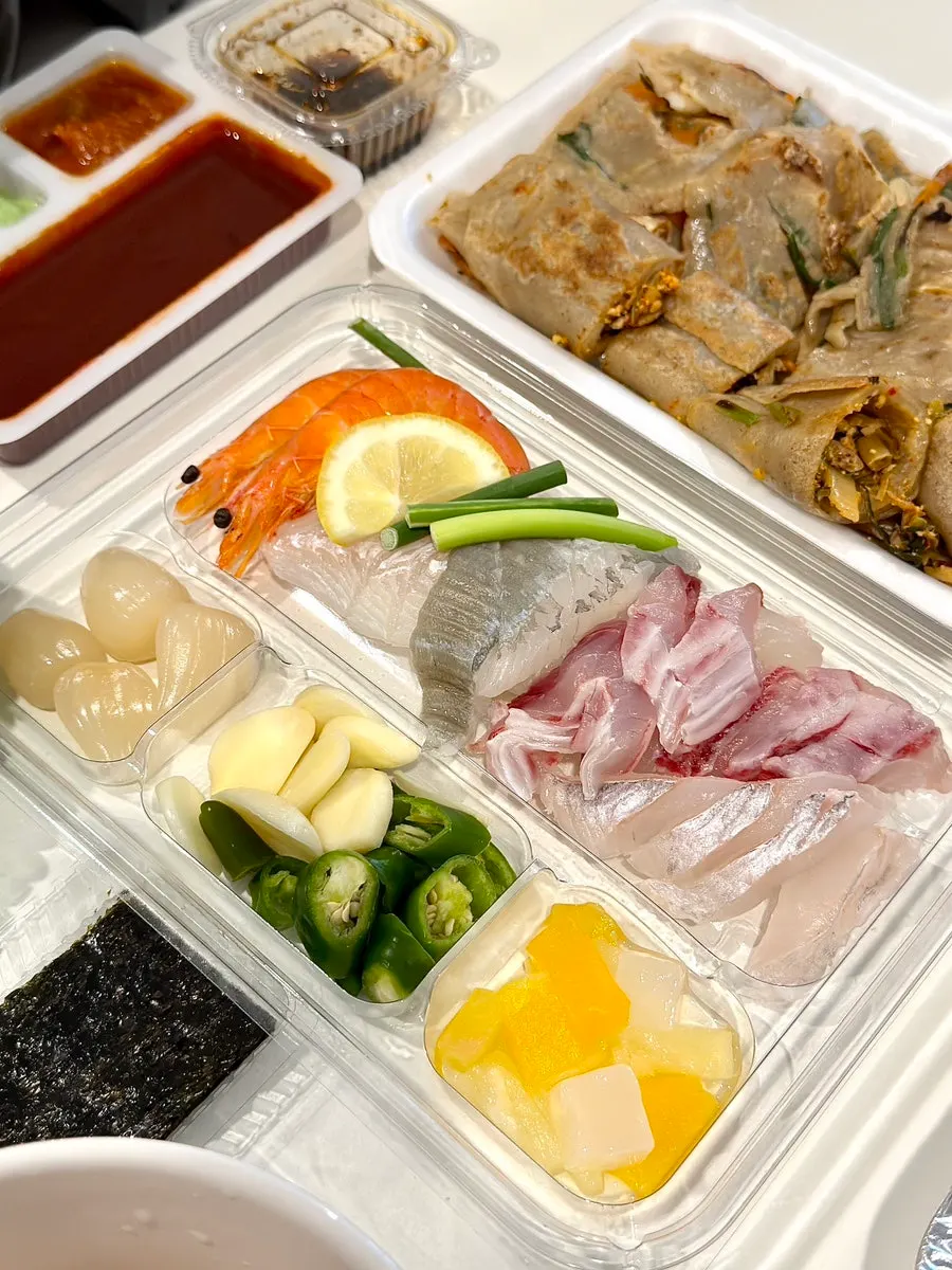 Seafood side dishes of abalone, sea squirt, shrimp, and whelk