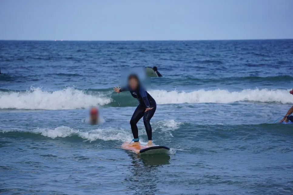 First time standing up on a surfboard riding a wave