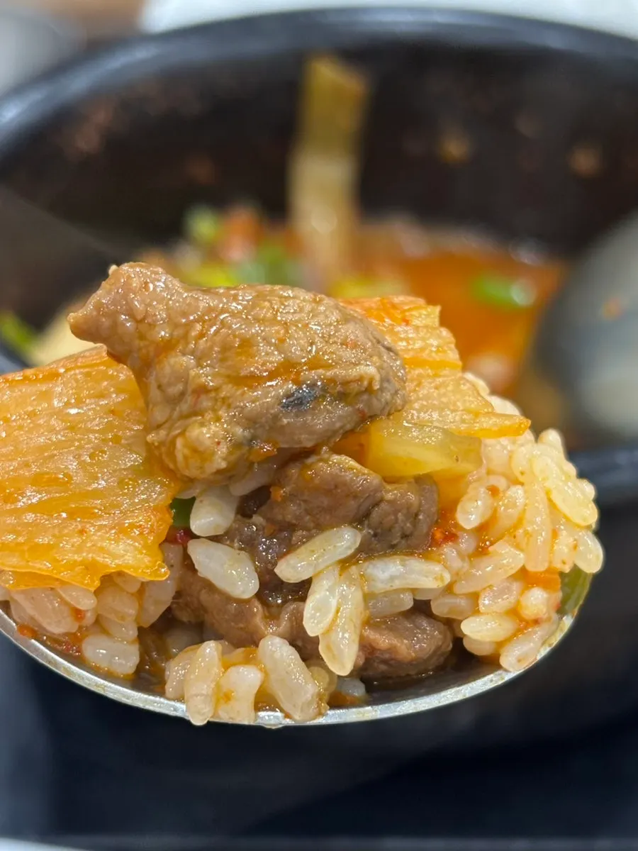 Rice mixed into the kimchi jjigae broth