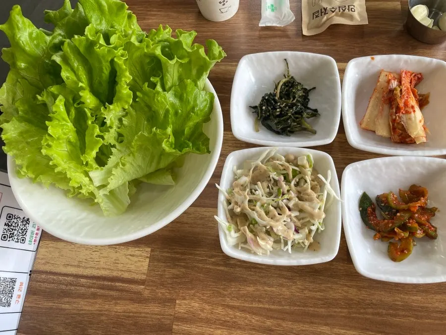 Side dish spread with individual servings of ssamjang, salt, and garlic