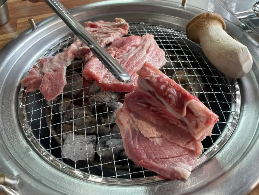 Two servings of fresh pork ribs served as five pieces
