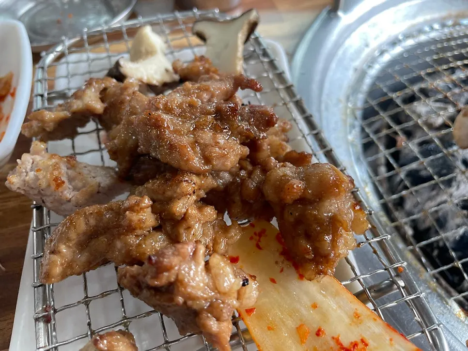 Marinated ribs grilling over charcoal