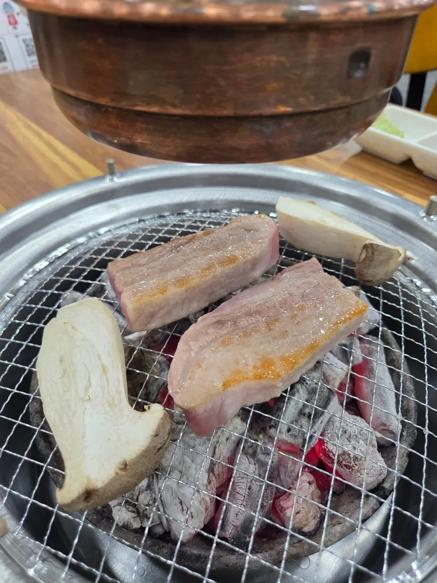 A plate of raw salt-aged pork belly and pork jowl