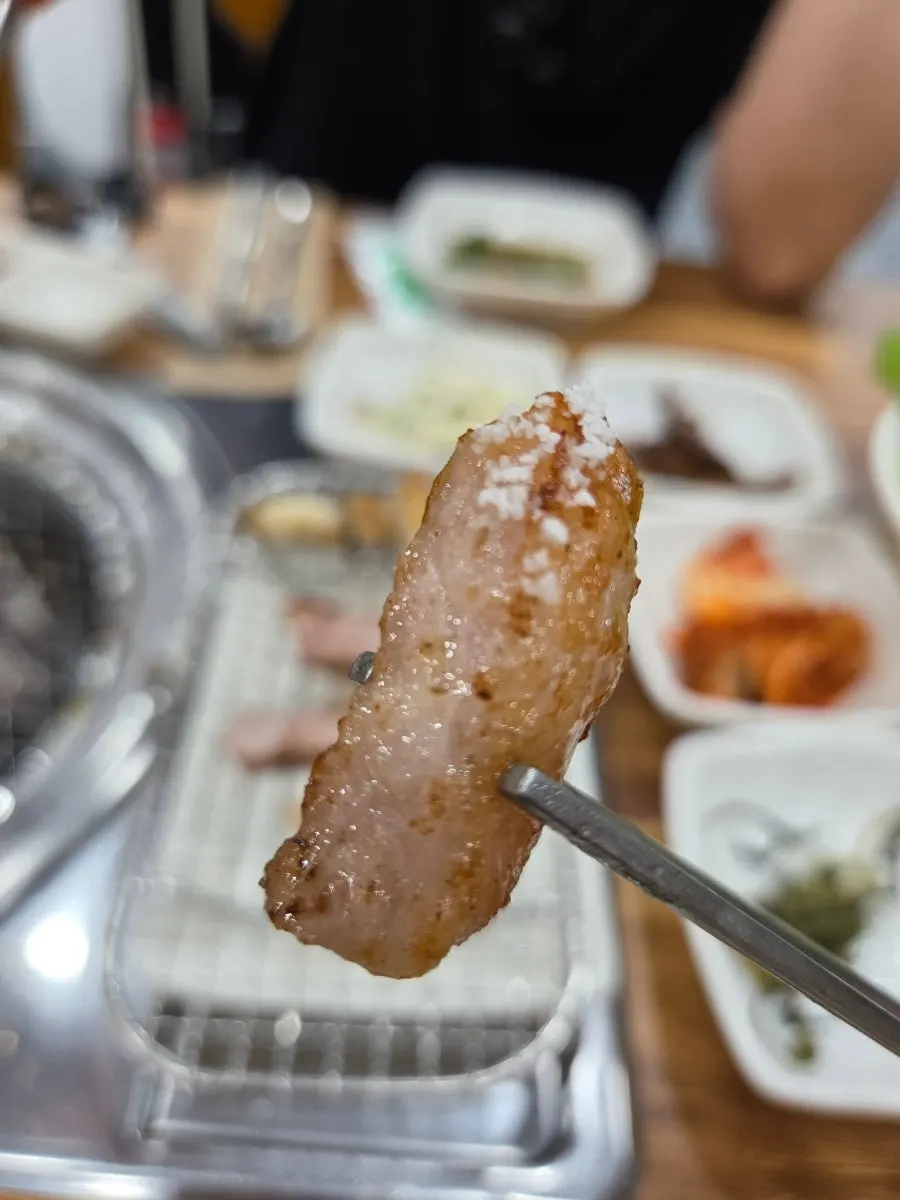 Pork jowl placed on the charcoal grill