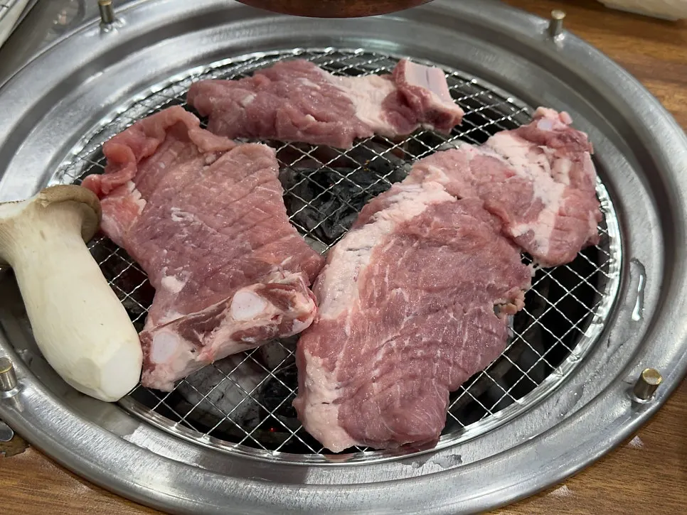 Fresh ribs grilling over charcoal at Yeoyejeong