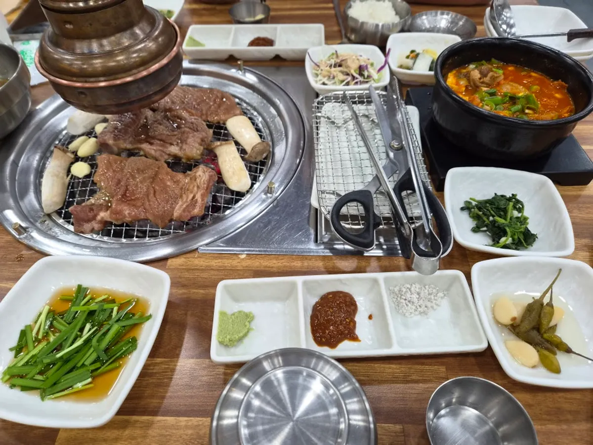 Marinated ribs grilling over Yeoyejeong's charcoal brazier