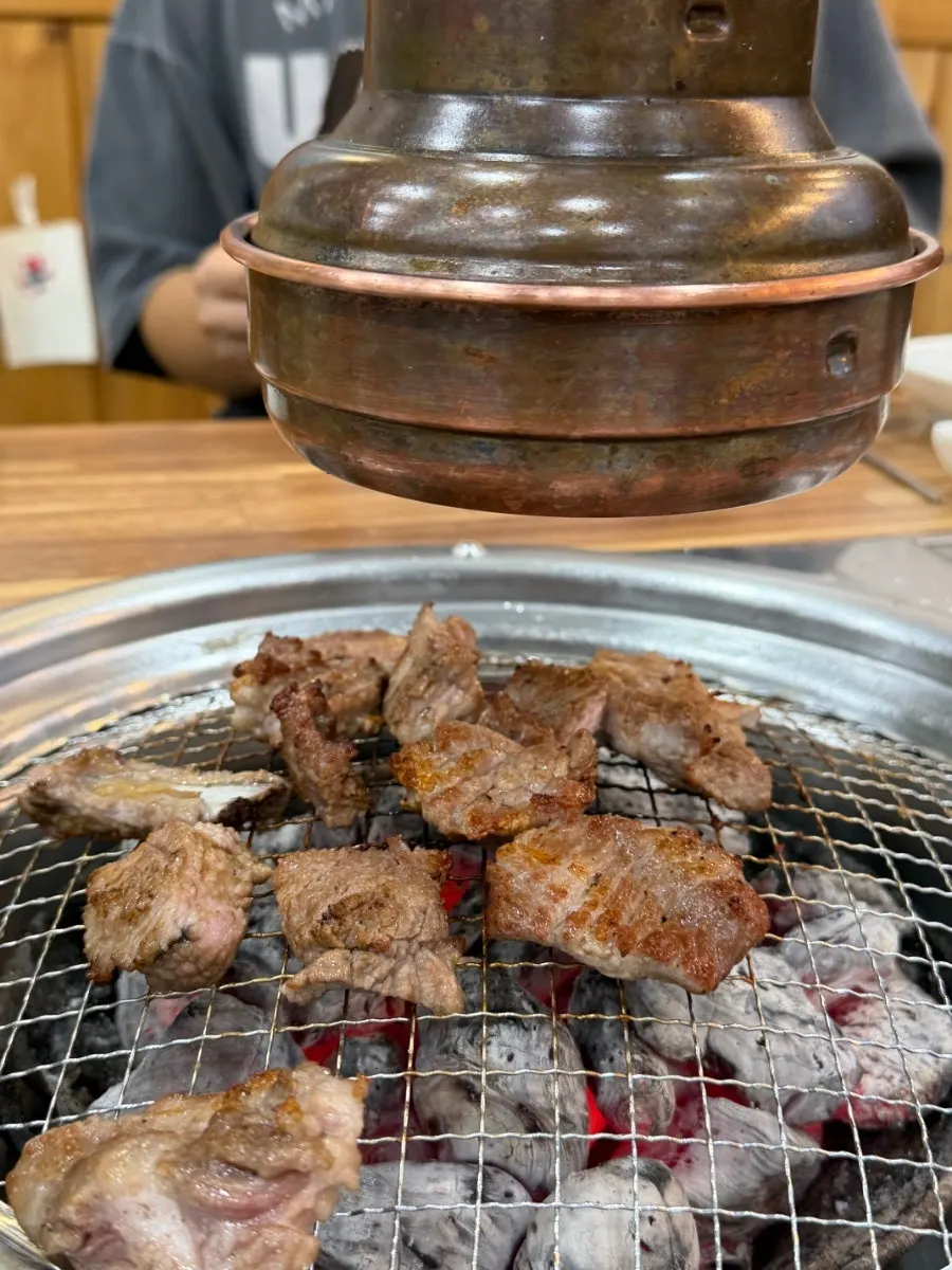 Fresh ribs grilling over binchotan charcoal