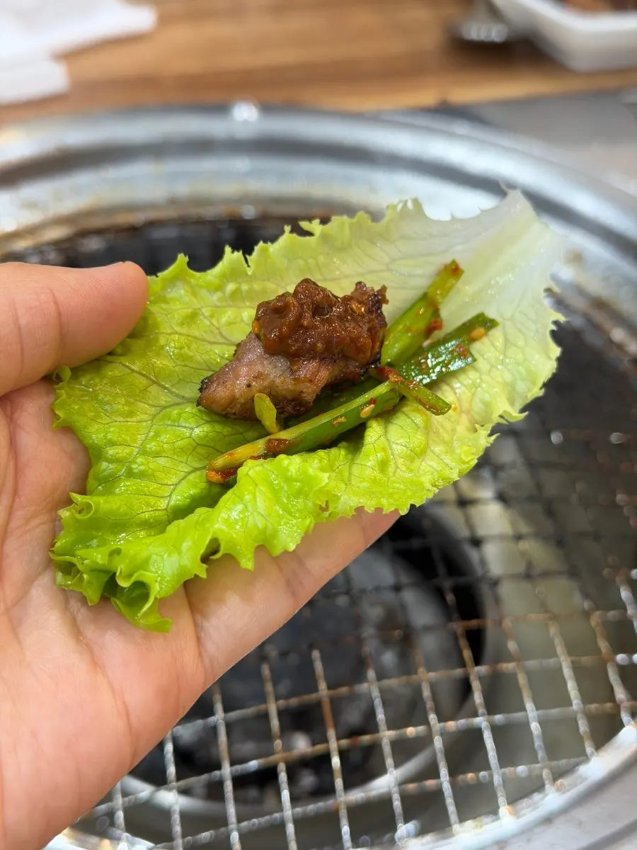 Marinated ribs grilling over charcoal