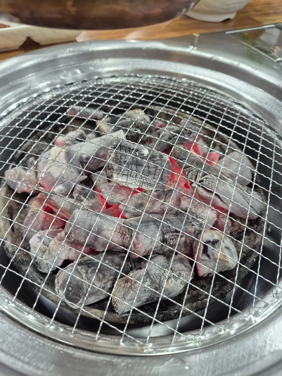 Side dishes and charcoal set up on the table
