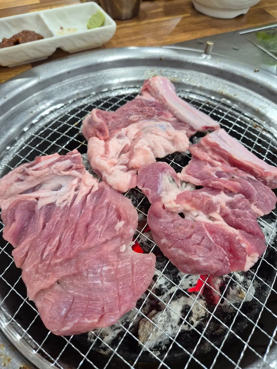 Fresh galbi grilling over charcoal