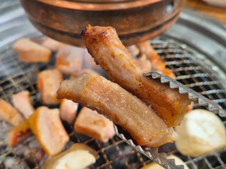 Pork jowl grilling to a golden brown