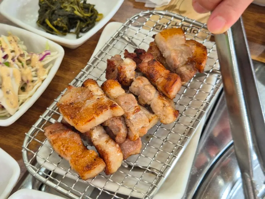 Pork belly and pork jowl piled on the grill