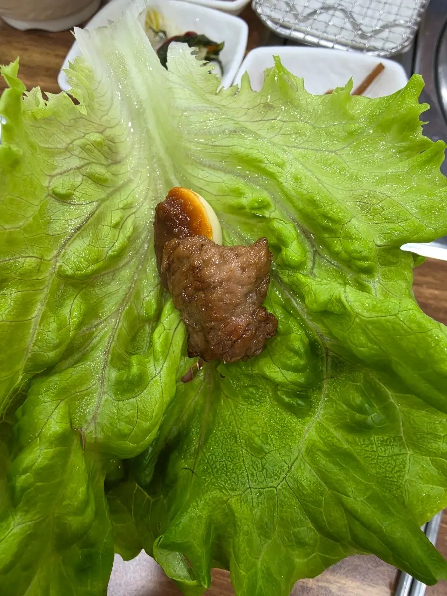 Grilled marinated ribs wrapped with garlic in lettuce