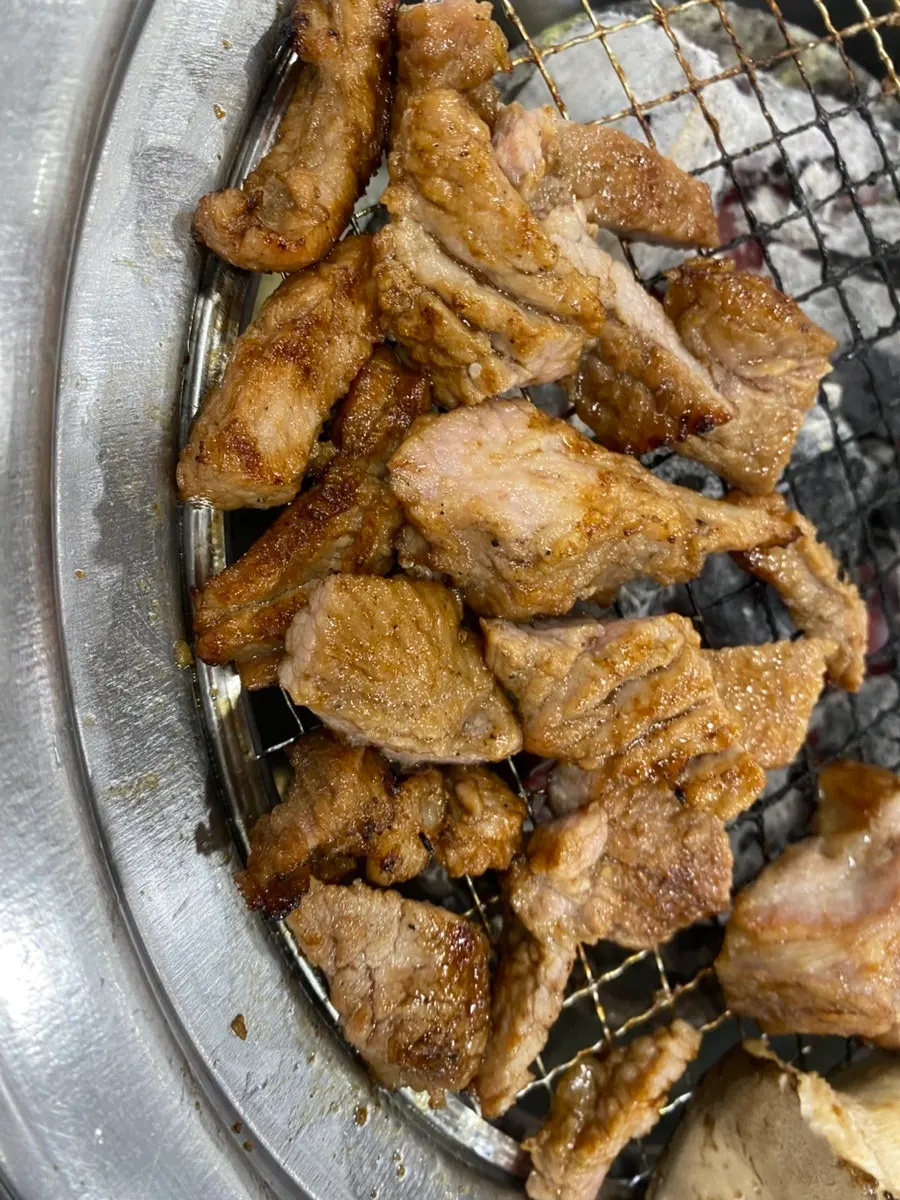 Close-up of marinated ribs sizzling on the grill