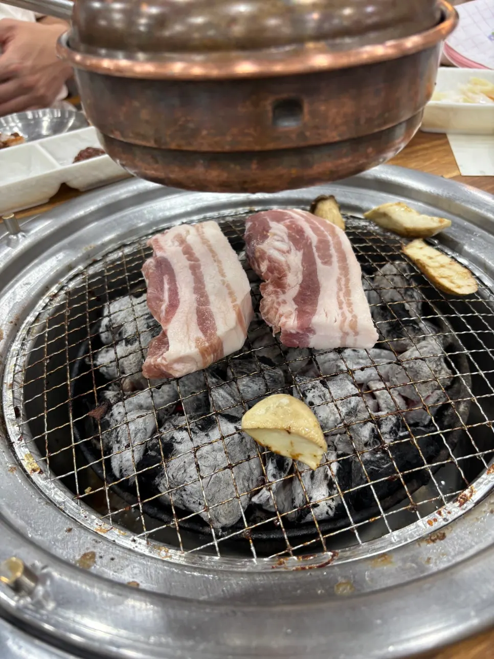 A lettuce wrap topped with ssamjang and meat
